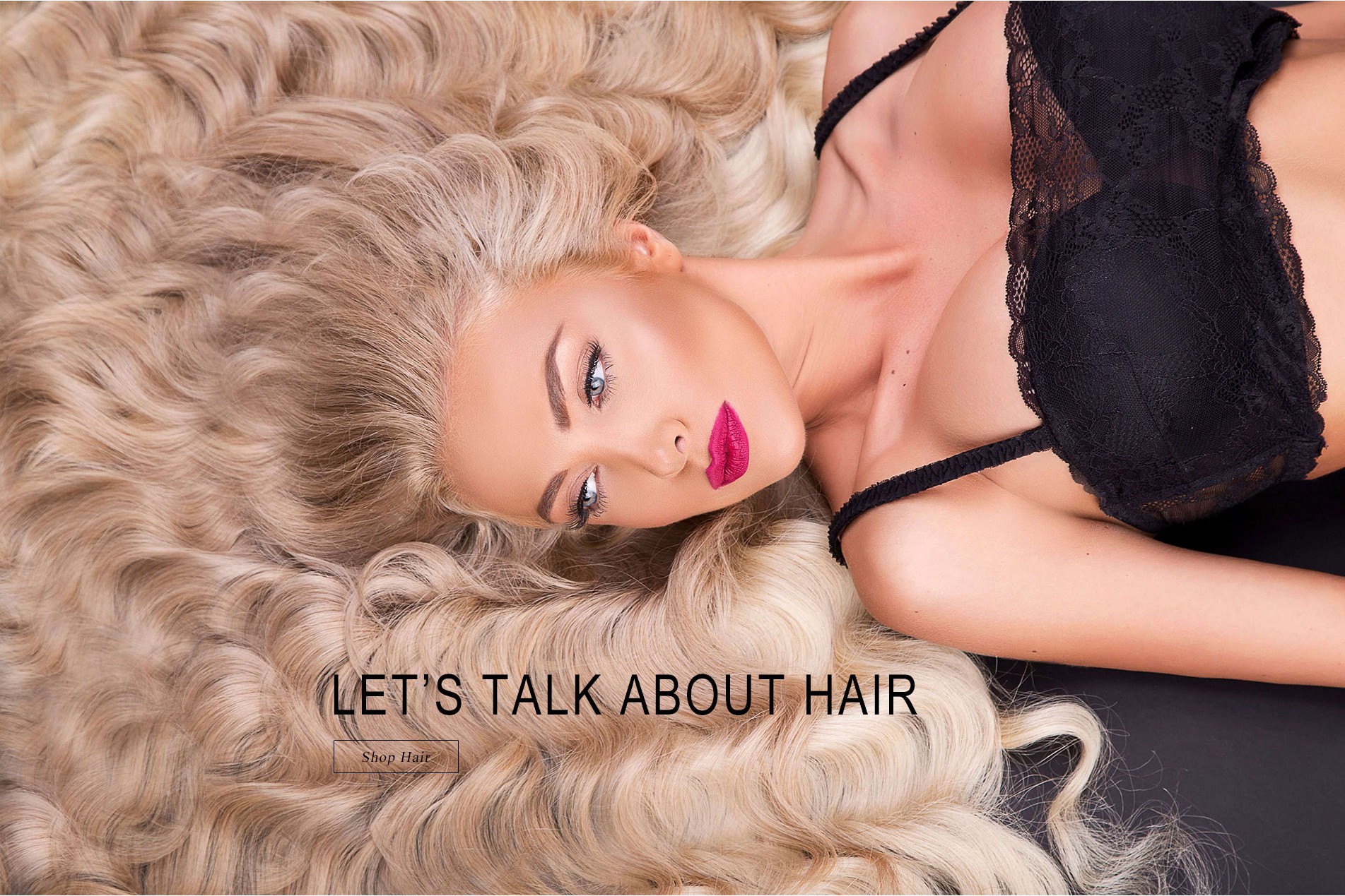 Blond woman with hair extensions laying down
